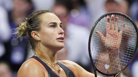 Aryna Sabalenka claps her racquet at the 2025 US Open