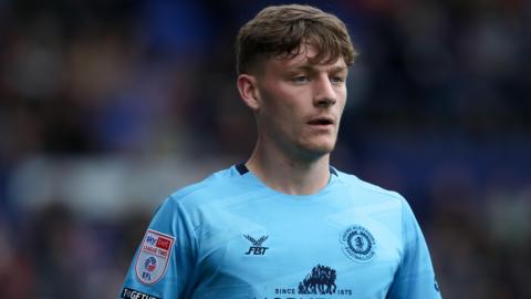Owen Lunt looks ahead in concentration during a match for Crewe