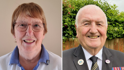A composite image of Margaret Lester and Tom Fennelly. On the left, Lester is smiling while looking directly into the camera. She has short brown hair and is wearing a blue and white girl guiding uniform, with a blue pin on her collar. Fennelly, on the right, is also smiling at the camera. He has short white hair and is wearing a black suit with various medals and badges pinned to it.
