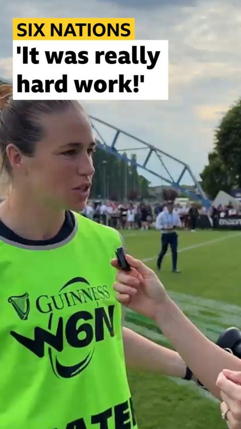 Emily Scarratt being interviewed and wearing green Women's Six Nations bib