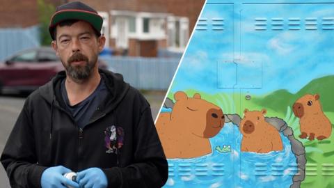 Martin Withers, who is wearing a black hooded jacket and a baseball cap, is staring directly at the camera. He is holding a can of spray paint and is wearing protective blue gloves. Split image alongside one of his works with Capybaras playing in water