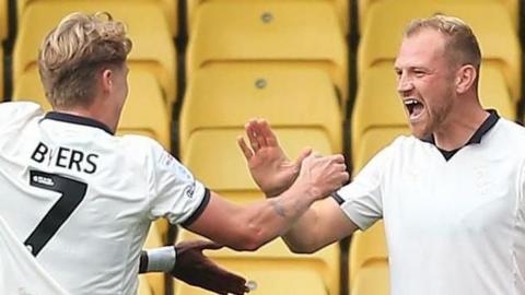 Ryan Croasdale celebrates with his Port Vale team-mates after scoring a goa