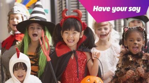 children dressed in Halloween costumes
