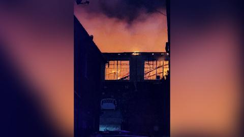 Flames are rising from a disused factory building.