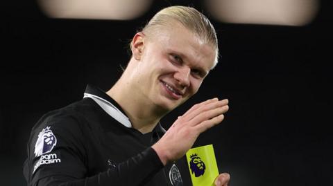 Erling Haaland celebrates with a player of the match award