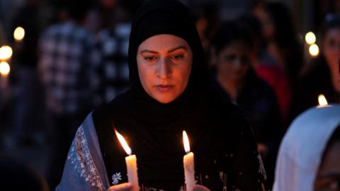 A demonstrator holds candles during a candle light vigil to condemn a suspected militant attack on tourists near south Kashmir’s scenic Pahalgam, in Srinagar April 23, 2025. REUTERS/Adnan Abidi