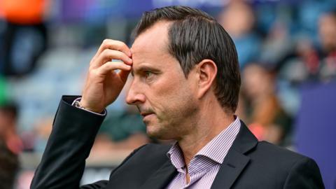 Julien Stephan scratches his head during QPR's 7-1 defeat at Coventry City