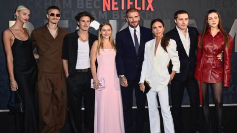 David and Victoria Beckham with their children, and their partners, at a Netflix red carpet event.