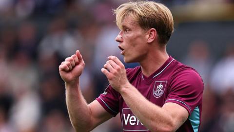 Burnley's Zian Flemming with both arms raised during the game against West Ham United