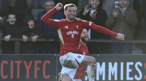 Matt Butcher celebrates the winner for Salford against MK Dons