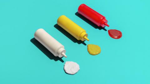 A mayonnaise, mustard and ketchup sauce bottle