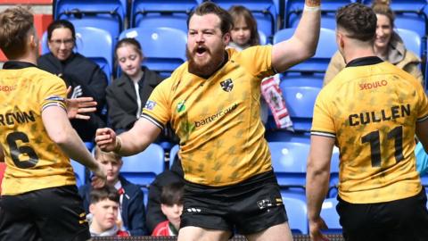 Tom Ashton celebrates a try