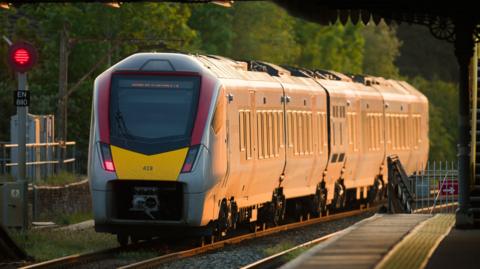 A train is pictured approaching the platform