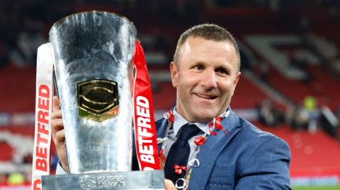 Hull KR boss Willie Peters hold the Super League trophy