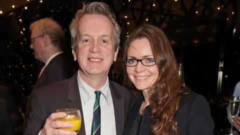 Frank Skinner and Cath Mason at an event in smart clothes
