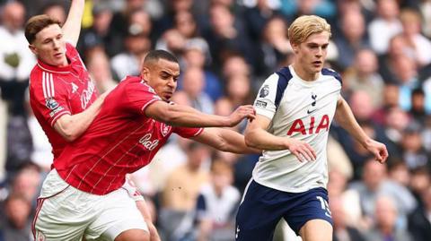 Lucas Bergvall dribbles with the ball with Murillo and Elliot Anderson in pursuit during last season's game between Tottenham and Nottingham Forest