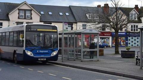 A Stagecoach bus stopped at a bus stop with a shelter in Shirebrook 