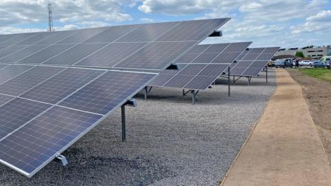 Solar panels on a gravel path. 