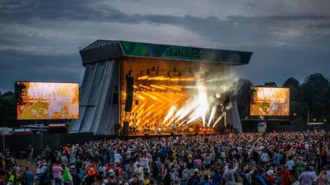 Stage with crowds watching and lights shining