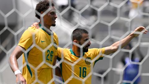 Australia's Tete Yengi celebrates scoring their first goal with Aziz Behich