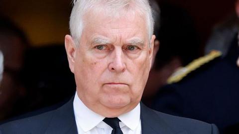 Andrew Mountbatten-Windsor in a dark suit and tie