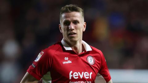 Emil Riis running on the pitch during a match