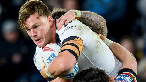 Hull FC's Liam Knight getting wrapped up in a tackle  