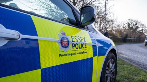 A Essex Police branded car parked on the side of the road