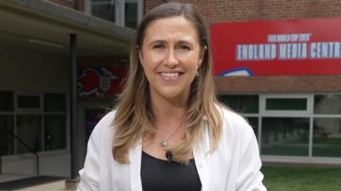 BBC Sport's Sarah Dawkins wearing a white shirt and black top