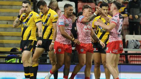 Castleford Tigers players react after a Leigh Leopards try