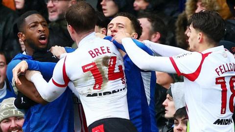 Portsmouth and Southampton players clash