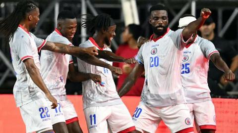 Haiti's forward #20 Frantzdy Pierrot celebrates with teammates after scoring his team's third goal during an international friendly football match between Haiti and New Zealand at Inter Miami CF Stadium in Fort Lauderdale, Florida on June 2, 2026.