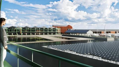 A computer-generated image showing a woman looking across a redeveloped dock complex. She stands on the left behind a green railing overlooking the deep-blue water of the dock. To the right are rows of closely packed dark-blue solar panels. In the background, redeveloped warehouses, modern buildings and small boats can be seen.