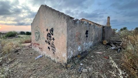 Derelict building with graffiti on it  
