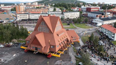 On a specially designed trolley with 224 wheels, Kiruna Church, is moved at a speed of half a kilometer per hour, during a relocation due to the expansion of an iron ore mine, in Kiruna, Sweden, August 19, 2025 in this drone view. 