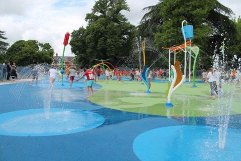 Children playing on the splash pad in Victoria Park