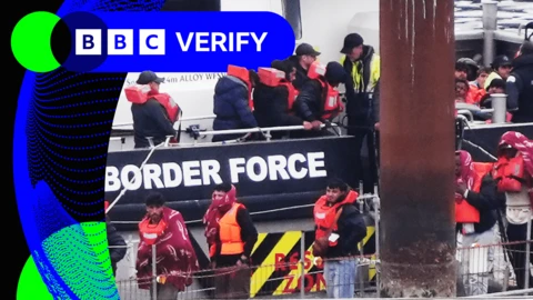 People believed to be migrants arrive in Dover on a Border Force vessel in May 2025