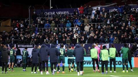 Man City players applauding the travelling fans. 