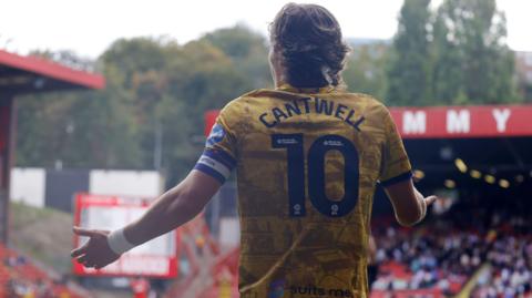 Blackburn Rovers captain Todd Cantwell holds his arms out in an appeal to the referee