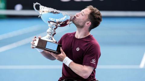 Alfie Hewett kisses the trophy after the men's wheelchair singles final match.