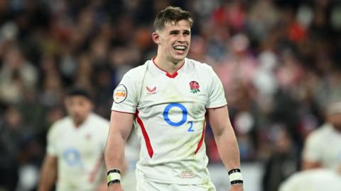 Seb Atkinson standing on the pitch in an England with his arms by his side``