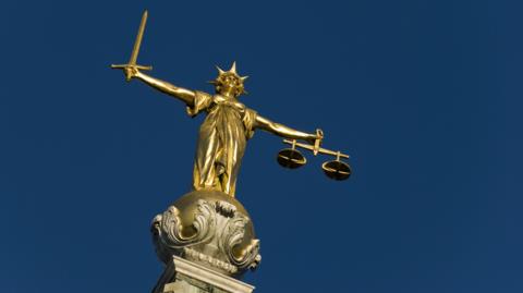 The Old Bailey golden figurehead, Lady Justice, bearing the sword and scales 