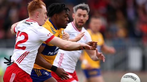 Tyrone's Seanie O'Donnell battles with Clare's Ikem Ugwueru