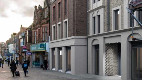 A computer-generated image shows how the new modern-looking buildings would look against the existing scene of the shopping street. Next door is an ornate Victorian building with a green Poundland shop front at ground level. The new buildings have grey stone lower floors with large windows. The upper floors are brick with grey stone window surrounds.