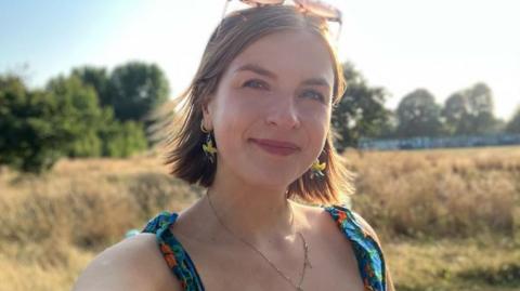 BBC journalist Erin Lister smiles at the camera 