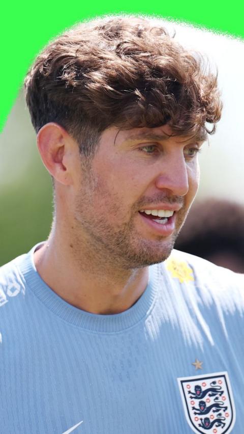 England defender John Stones. He is wearing a light-blue England training top.