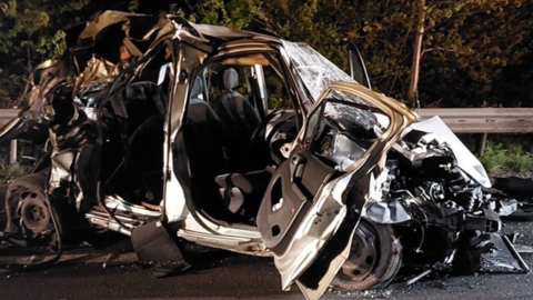 A crushed van on the hard shoulder of the motorway
