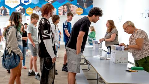 Students queue to get their results at Llanishen High School on August 20, 2026 in Cardiff, Wales.