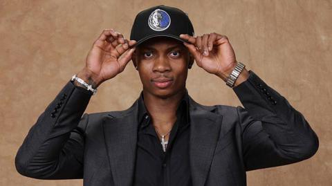 Tobi Lawal poses for a photo after being selected in the 2026 NBA Draft