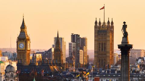 A high angle cityscape of Westminster including Big Ben, Houses of Parliament and Nelson's column